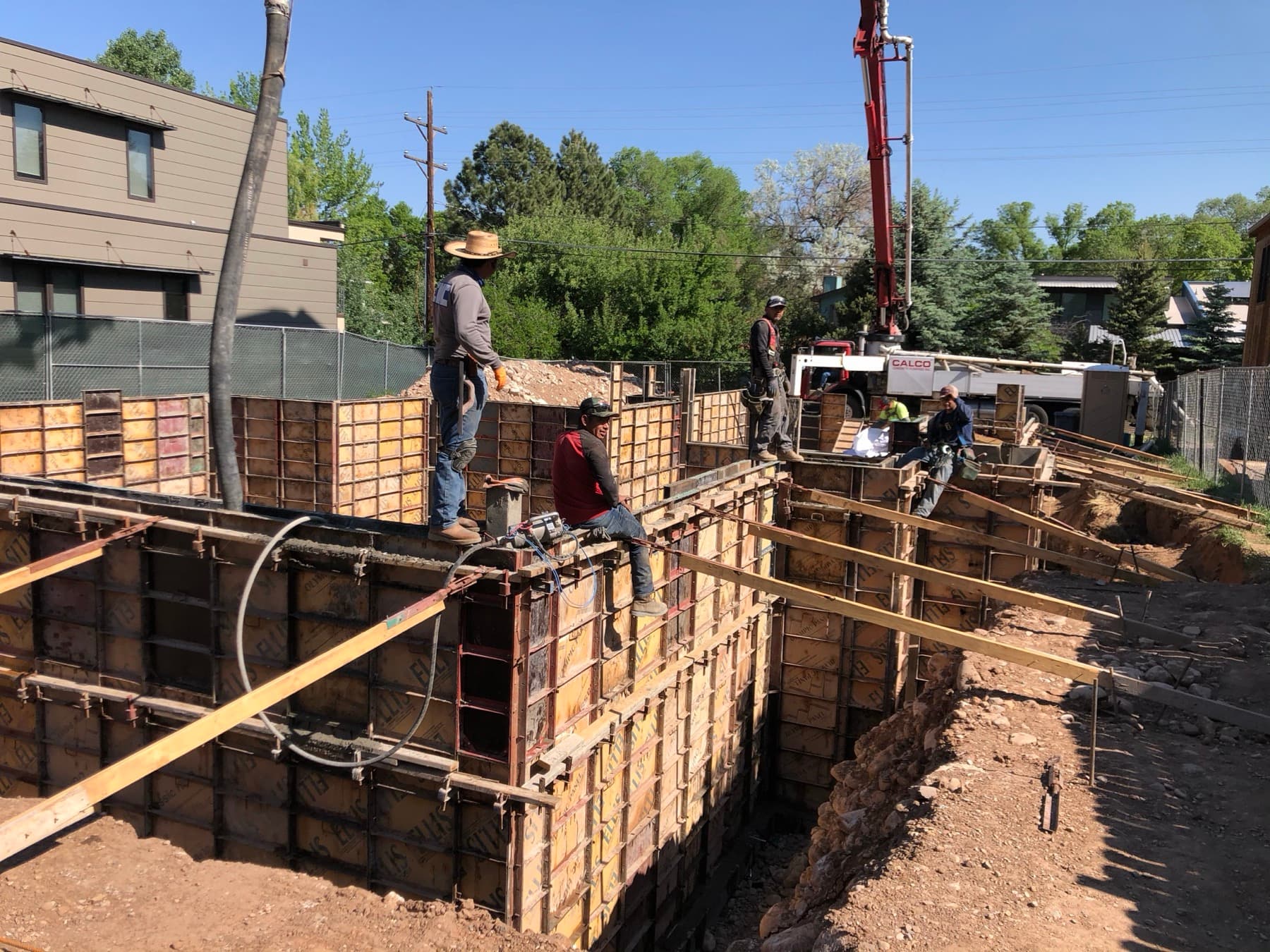 Crew setting foundation formwork on an in-town lot