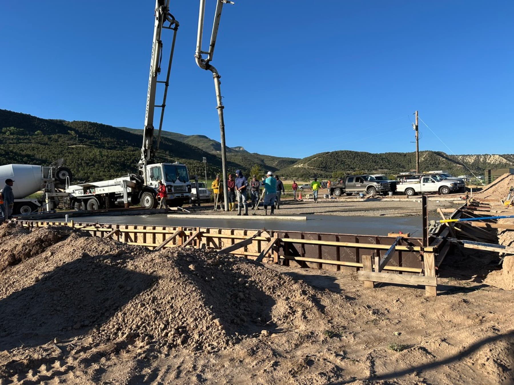 Slab pour with pump truck under a clear sky